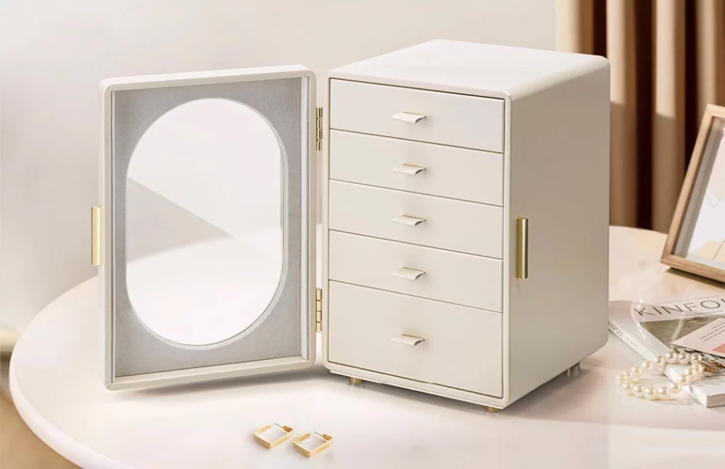 Elegant jewelry box with glass door on a vanity, showing practical storage
