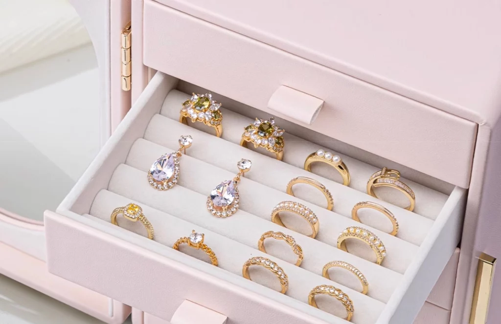 Jewelry box open showing organized rings, earrings, necklaces and more
