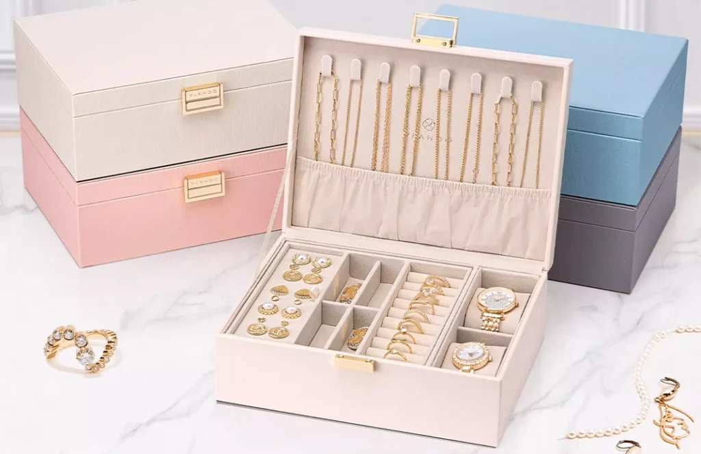 Blush, ivory, apricot, and gray leather jewelry boxes displayed as elegant home decor