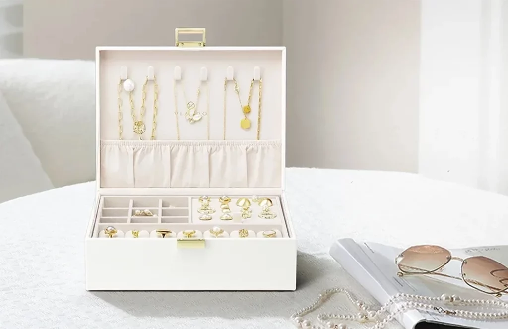 Elegant ivory leather jewelry box organizer for women on a vanity, blending decor and function