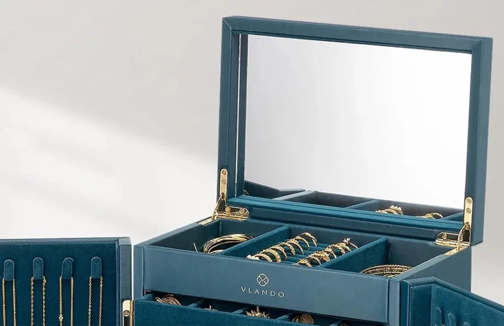 Jewelry box with built-in mirror for easy accessorizing, placed on a vanity with elegant decor