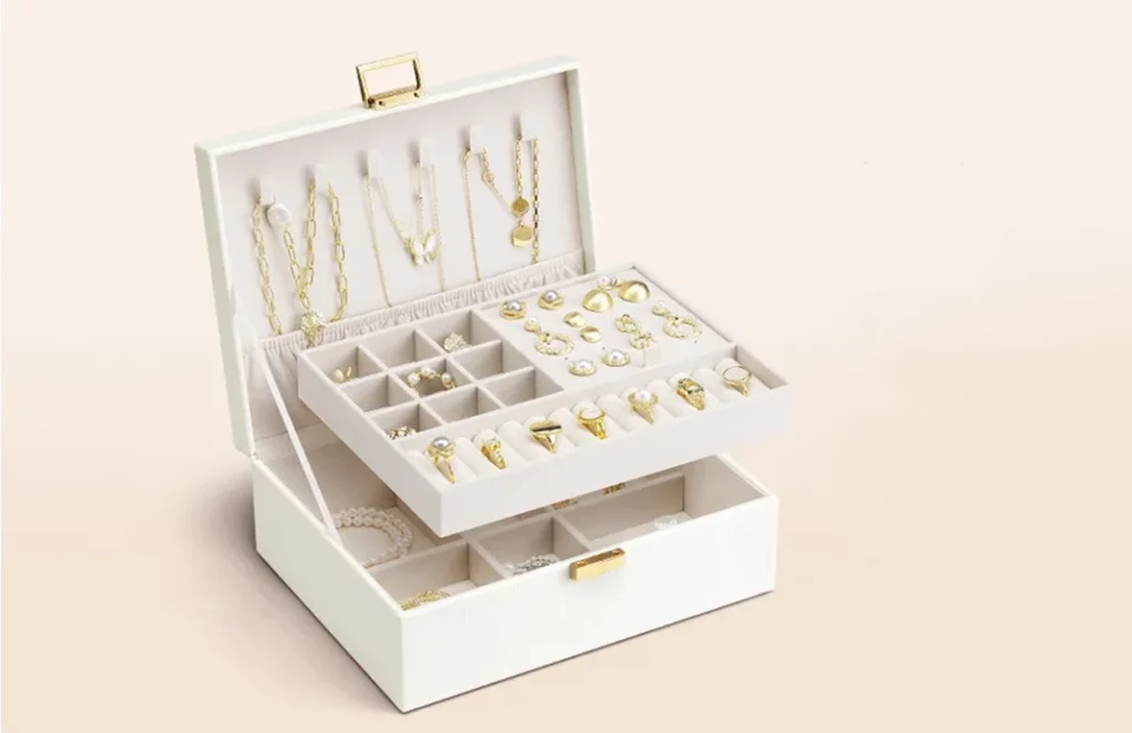Open view of two-layer jewelry box for women with velvet compartments for rings and bracelets