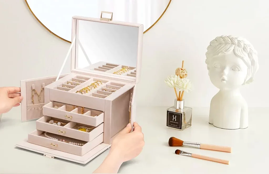 Open portable jewelry box organizer showing drawers, hooks, and velvet compartments