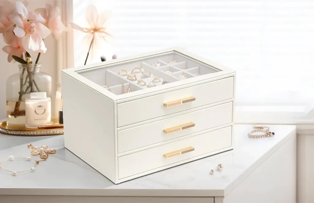 Glass-top 3-drawer jewelry box on a vanity for at-a-glance selection