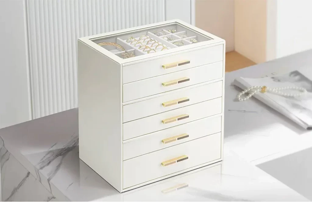 Glass-top 6-drawer jewelry box on a vanity for at-a-glance selection